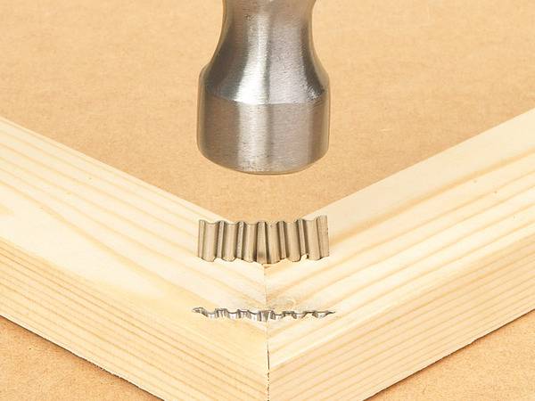 Drive the corrugated fastener with a hammer.