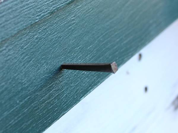 Use cut masonry nail to secure the window frame.
